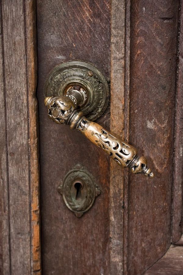 Ornate carved door handle and wood detail